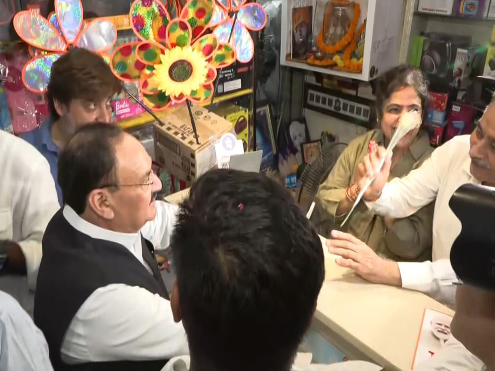 Union Minister JP Nadda interacts with local shopkeepers (Photo/ANI)